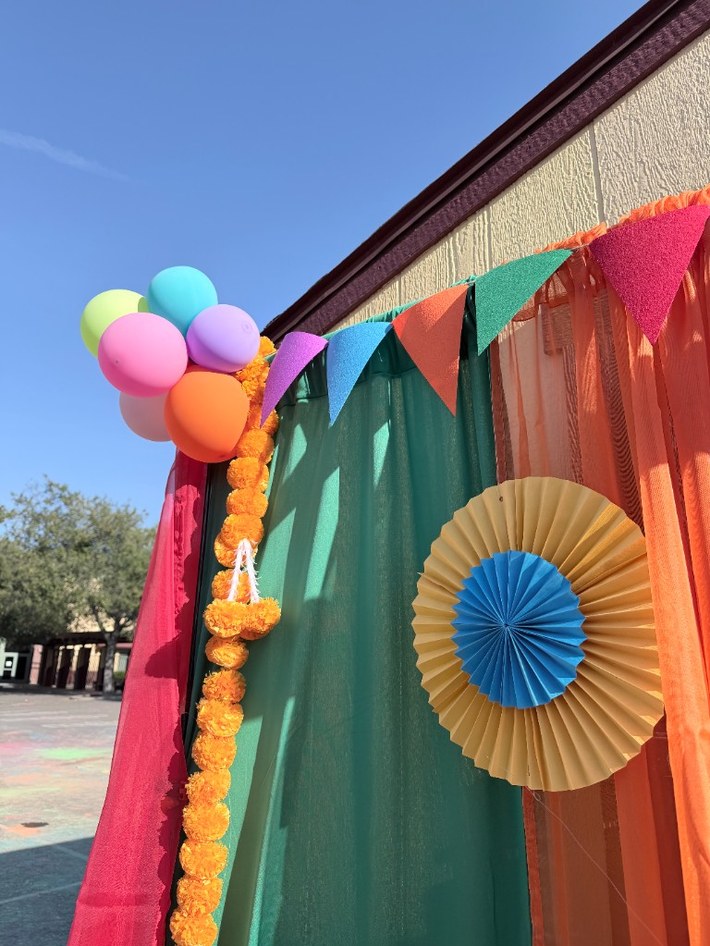 Marigold garlands, bunting, and balloon accents